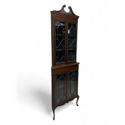 Edwardian mahogany corner display cabinet, scrolled swan neck pediment over astragal glazed doors, fabric lined interior, on cabriole feet 