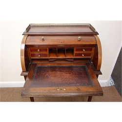  Edwardian inlaid mahogany cylinder front writing desk, with pierced brass galleried top, interior with drawers, compartments and pull out inset leather writing surface above a single drawer, on square tapered supports, with ivorine plaque for 'Charles Jenner & Comp. Edinburgh' W77cm, D53cm, H110cm  