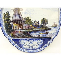  Large 19th century Delft Polychrome wall plaque of shaped form painted with figures, sailing boats and windmills in a river landscape  