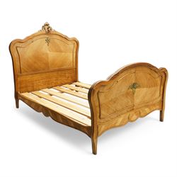 Mid-20th century French walnut small double 4' 2'' bedstead, shaped and moulded headboard with shell and curl acanthus leaf carved pediment with extending flower heads, quarter-matched veneers decorated with applied mouldings and cast gilt metal ribbon tie 