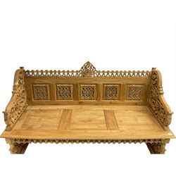 Carved teak garden bench, the cresting rail carved and pierced with foliate design, shaped arms and end supports decorated with scrolling foliage and flower heads