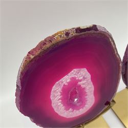 Pair of pink agate slices, polished with rough edges raised upon gilt metal stands, H20cm