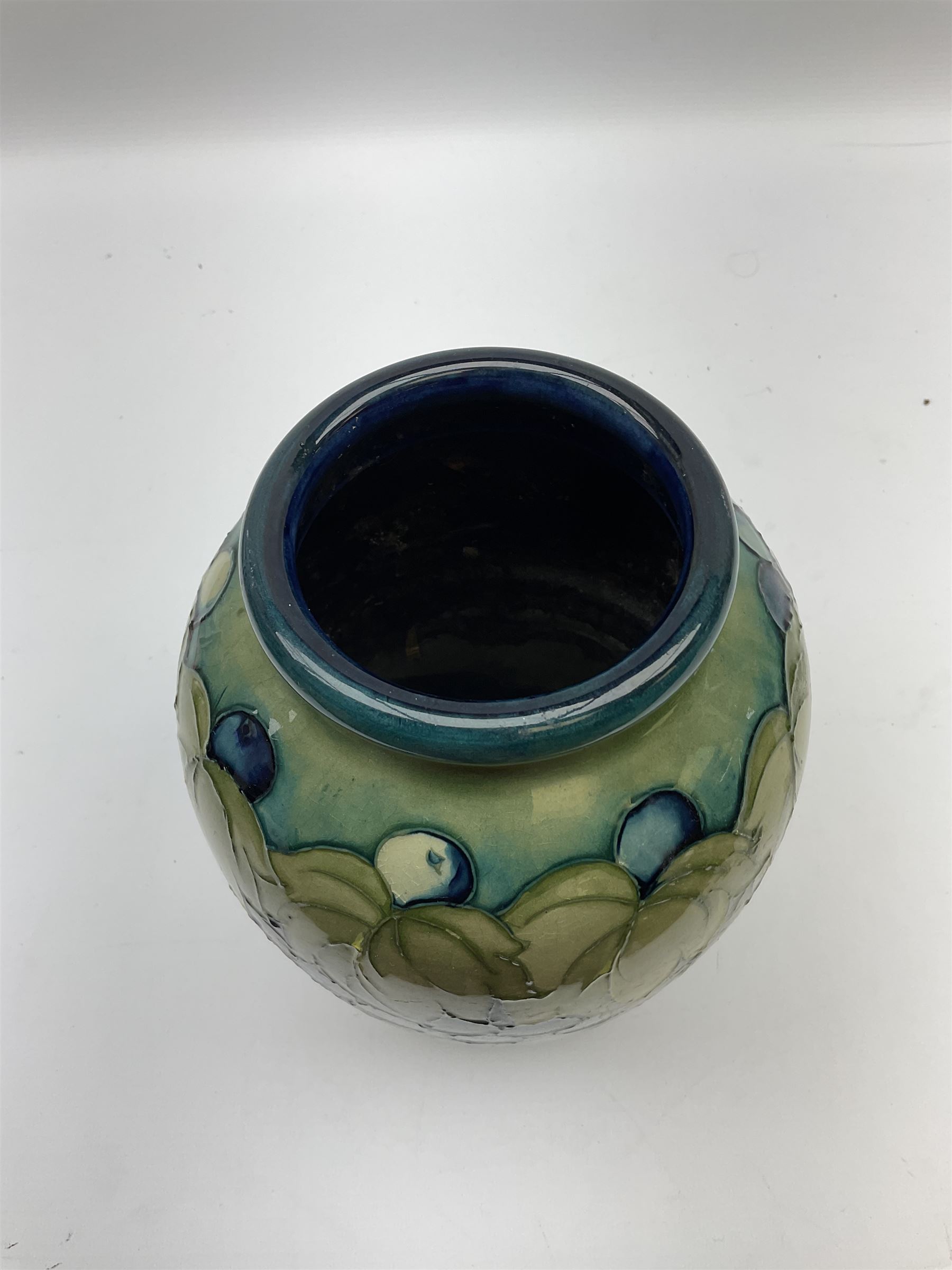 Moorcroft Grape and Leaf pattern baluster vase on green and blue ground, with impressed and painted mark beneath, H24cm