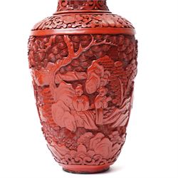 Pair of Chinese late Qing dynasty cinnabar lacquer vases, carved with scenes of figures in a landscape, H25cm (2)