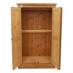 Modern stripped pine two-door wardrobe, the fielded panel doors with turned knob handles, opening to a double rail hanging interior, beneath a stepped cornice and raised on plinth base