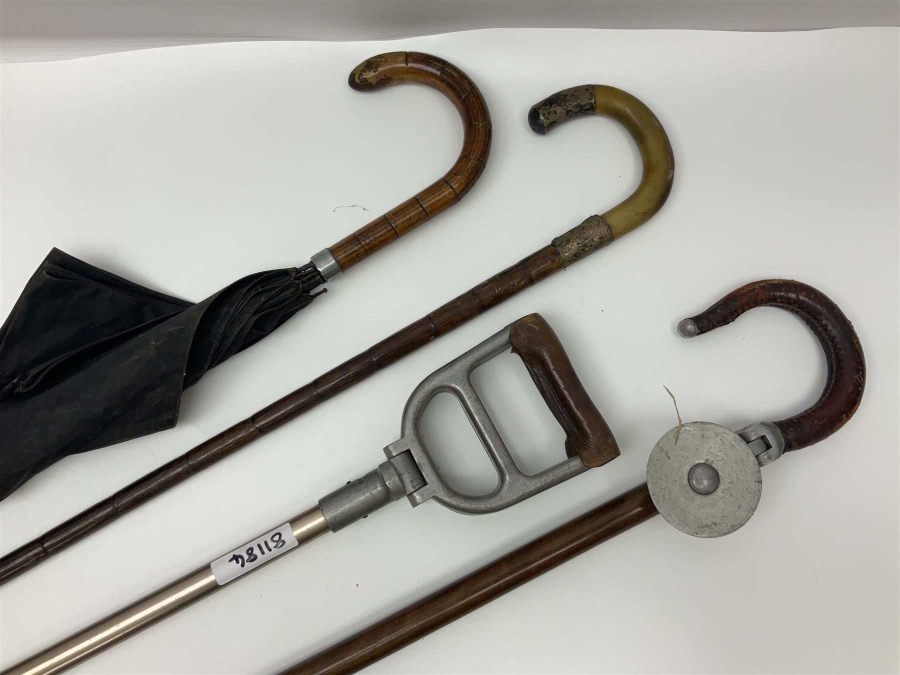 Early 20th century curved horn handle walking stick with hallmarked silver mounts, engraved L Russell 1918, together with a shooting stick by William Mills Birmingham, with leather handle, 'The Featherwaite' shooting stick and an umbrella with wooden handle