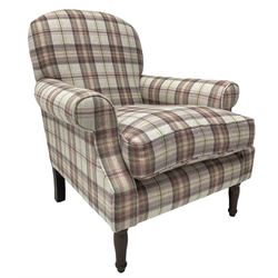 Traditional shape armchair, upholstered in pink and lilac checkered fabric, rolled arms with loose seat cushion, on turned front supports 