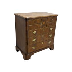Late 20th century walnut veneered television chest in Georgian style, rectangular top over simulated drawer front with central marquetry star inlay, opening to a shelved TV compartment, lower section fitted with one long drawer, brass handles and ogee bracket feet