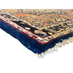 Persian Herati design indigo and red ground carpet, decorated with floral motifs, arched border