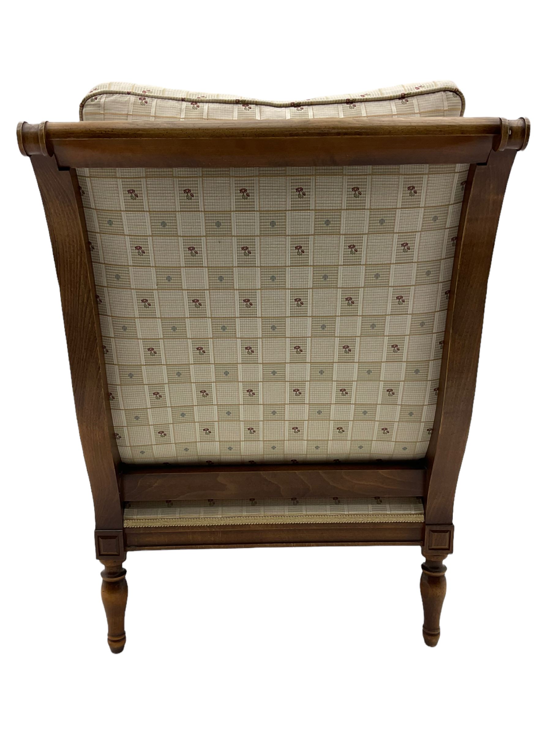 Wesley Barrell - beech framed armchair, upholstered in floral patterned fabric, on turned supports