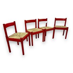 Vico Magistretti - mid-20th century circa. 1970s set of four beech framed dining chairs in red finish, with drop-in rush seats