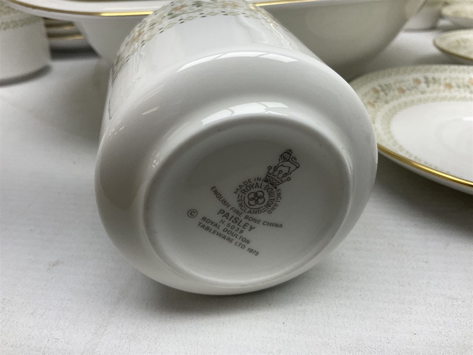 Royal Doulton Paisley pattern tea and dinner service for twelve, comprising dinner plates, side plates, soup bowls, dessert bowls, tea plates, two lidded tureens, sauce boat and saucer, sucrier and jug, oval serving dish and teacups and saucers