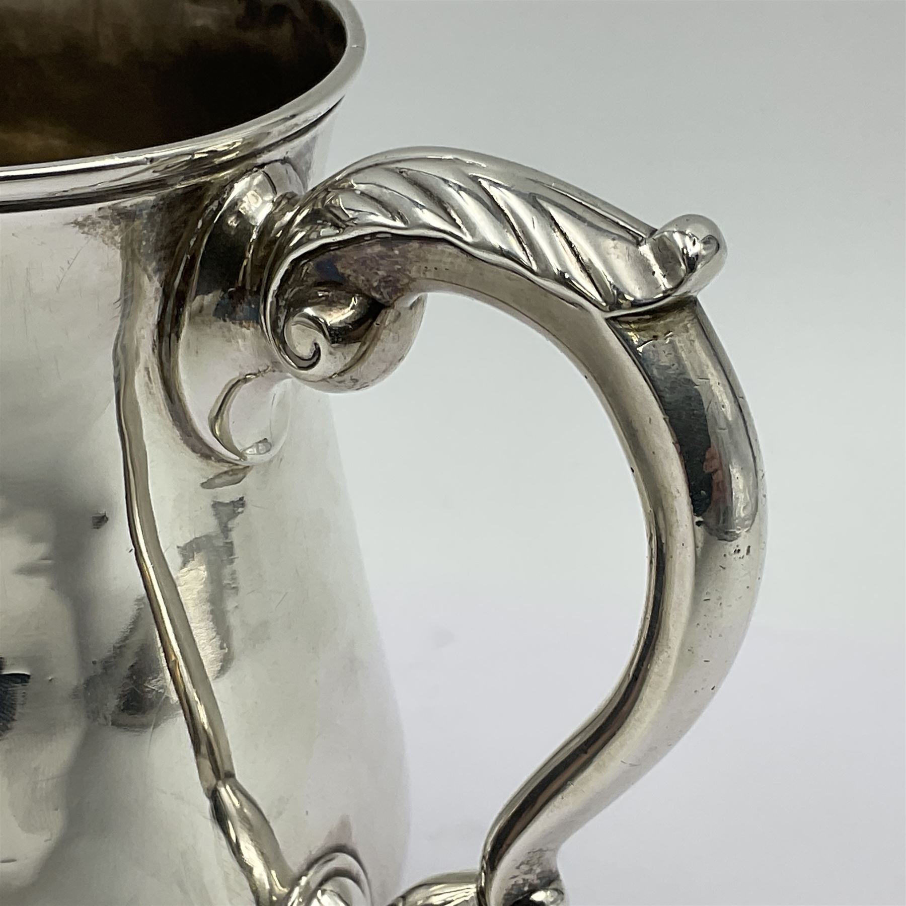 George II silver tankard, of waisted baluster form with acanthus capped C scroll handle, the body engraved with a lion rampant, upon a circular spreading foot, hallmarked Gabriel Sleath & Francis Crump, London 1754, H13cm