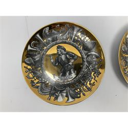 Three Fornasetti plates from the Melodramma series, each depicting a operatic portraits within a border of operatic emblems on gilt ground, with printed mark beneath, D25cm 