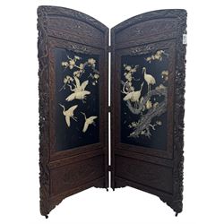 Meiji period (1868–1912), Shibayama lacquer carved hardwood two-fold screen inlaid with mother-of-pearl, bone, and ivory, decorated on one side in high relief and inlaid in a  Shibayama manner with oriental storks flying below flowering branches,  the reverse lacquer panels depicting flowering cherry trees. This item has been registered for sale under section 10 of the APHA Ivory Act.