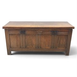 Large 17th century oak coffer, plank top with moulded edge, four panel front with channel moulded uprights, retaining original wrought iron strap hinges and central lock plate, panelled ends, raised on stile supports