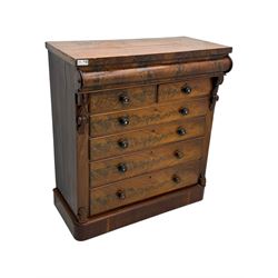 19th century flame mahogany Scotch chest, frieze long drawer above two short and four long graduating drawers, with turned knobs scrolled carved side bracket 