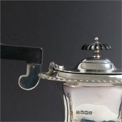 Edwardian silver four piece tea service, comprising coffee pot, teapot, twin handled open sucrier and milk jug, all of oval bellied form, part fluted and with oblique gadrooned rim, with Bakelite type handles and finials to teapot and coffee pot, hallmarked Fordham & Faulkner, Sheffield 1913