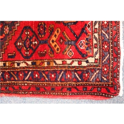  Persian Hamedan red ground rug, central medallion, repeating border, 207cm x 105cm  