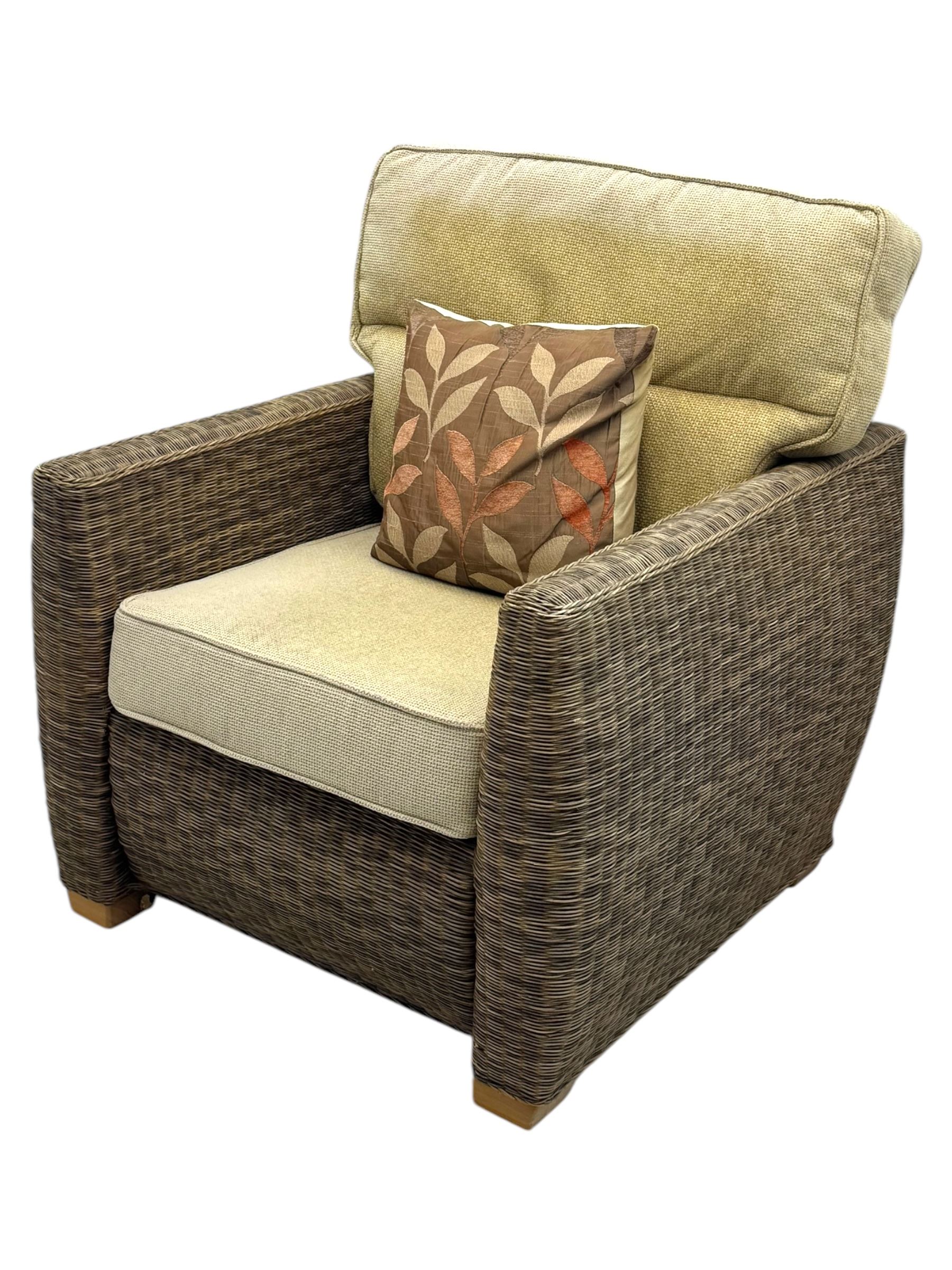 Contemporary two seat rattan conservatory sofa with loose cushions, and pair of matching armchairs, with upholstered seat and back cushions in a beige fabric, curved arms and front complete with scatter cushions 

Chairs (H 92cm, W 75cm, D 84cm)
Sofa (H 92cm, W 130cm, D 84cm)