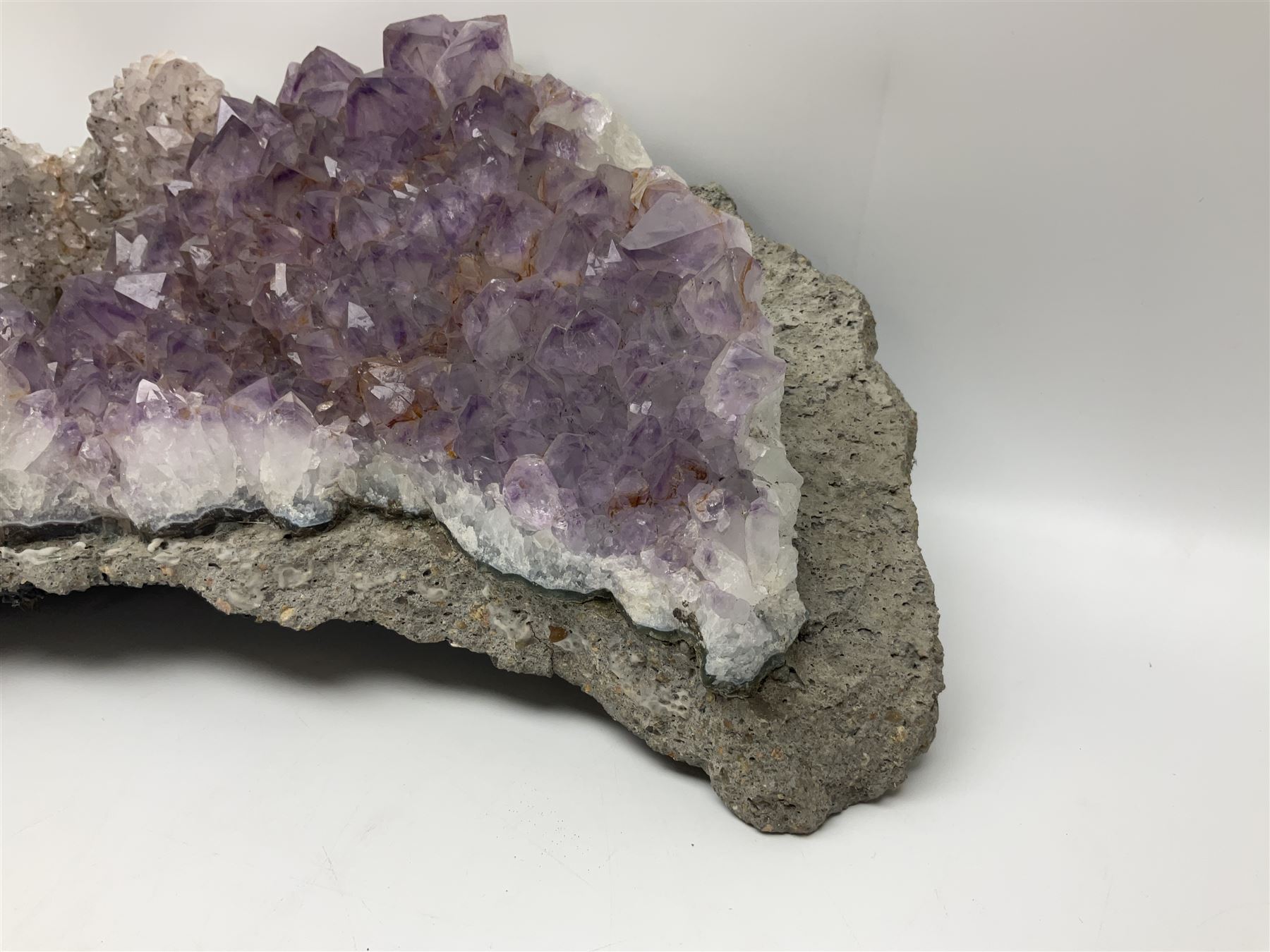 Amethyst crystal geode cluster, with well-defined crystals of various sizes, H13cm, L46cm