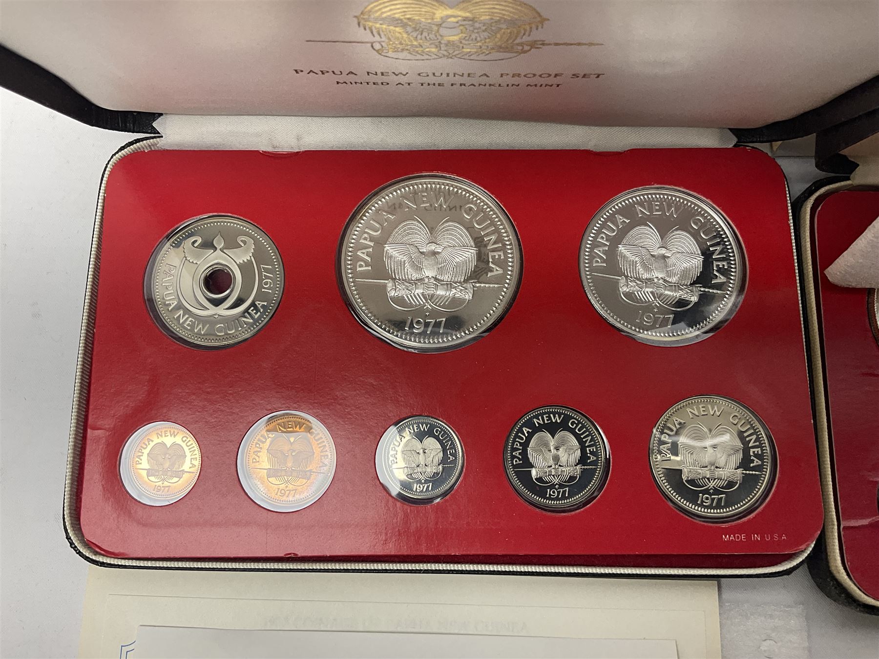 Four Papua New Guinea proof eight coin sets, from ten kina to one toea, comprising First Coinage of Papua New Guinea 1975 proof set, 1976, 1977, and 1979 proof sets, the 1977 and 1979 sets containing 925 silver ten kina and 500 silver five kina coins, all minted at the Franklin Mint, cased with certificates (4)