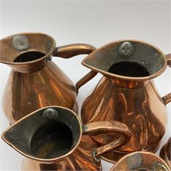 Eight graduated copper haystack jugs, ranging from quart to 1/8 pint, largest H16cm, smallest 6.5cm. 