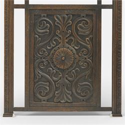 20th century carved fireside accessories; a carved coal bucket with metal liner and a carved fire screen