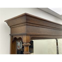 Arts and Crafts period oak mirror back dresser, projecting cornice above rectangular bevelled mirror and shelf, two turned supports, inset copper panel with embossed decoration, rectangular moulded top over two drawers and two panelled cupboard, moulded plinth base, brass and copper strappings and handles 