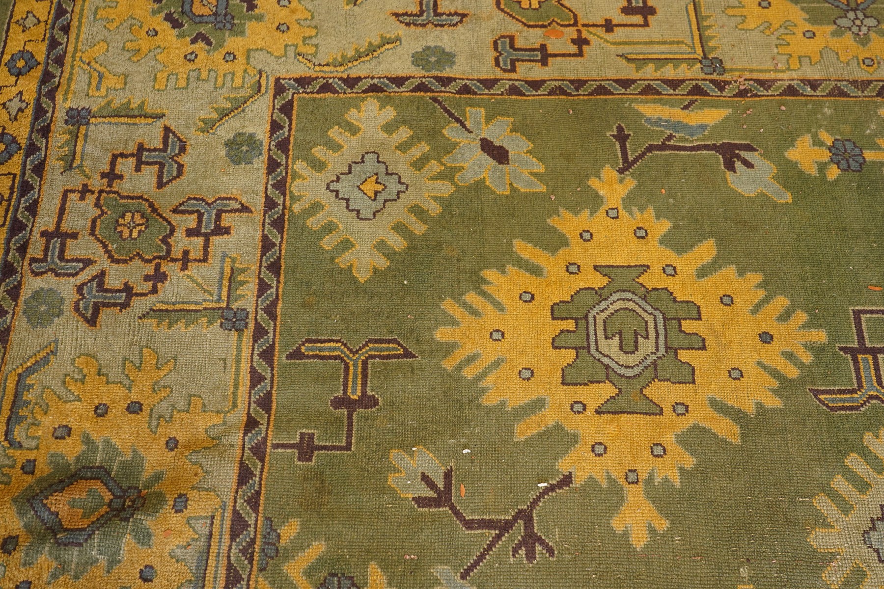 Lage Turkish Oushak green ground carpet, the field decorated with large stylised plant motifs and geometric design, the sage green guard band with further repeating foliate motifs