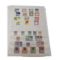 Mostly Commonwealth or Empire stamps including Queen Elizabeth II Northern Rhodesia, Nyasaland, Solomon Islands, Aden, Bermuda, Grenada 'Associated Statehood' overprints, King George VI Falkland Islands Dependencies with values to one shilling etc, mixture of mint and used, housed in a green stockbook