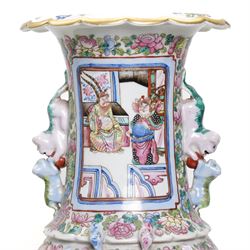 Large pair of 19th century Cantonese famille rose vases, each painted with various courtly scenes, including a display of warriors fighting on horseback before an official and his attendants, double Buddhist lion handles and applied at the shoulders with chilong, the lower band painted with Greek key motif, H58cm (2)