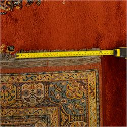 Persian Kashan prayer rug, rust red field with mihrab arch design, suspended floral hanging lamps, and a central flowering vase framed by columnar supports enclosed by palmette and meandering vine border