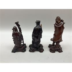 Small Oriental carved wood figures to include seated Buddha example, and a quantity of brass to include pair of candlesticks and cannons etc