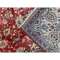 Persian Mahal carpet, red ground with overall floral design, decorated with stylised flower heads and bird motifs, scrolling multi-band border