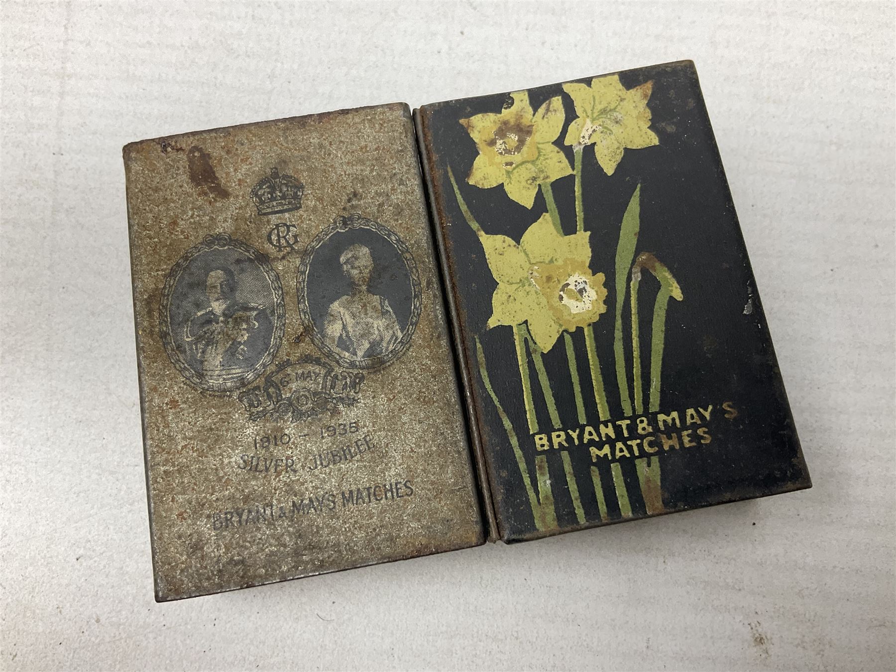 Victorian leather cigar protector with metal match striking plate on the end and internal spring to hold the cigars in place; expands for differing lengths of cigar, minimum L12.5cm; another similar leather cigar case marked Middlemore's Patent with attached vesta case and striker; three Bryant & Mays tin-late matchbox holders including 1935 Jubilee; and small box of matches (6)