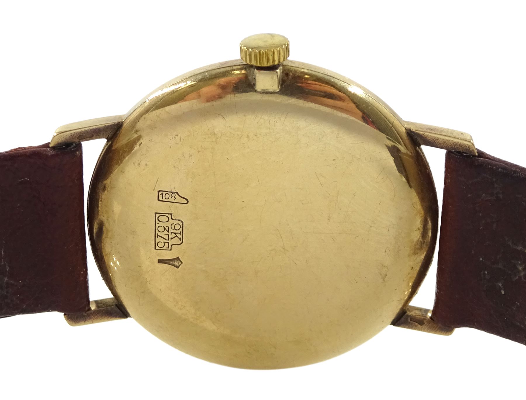 Manis gentleman's 9ct gold manual wind wristwatch, hallmarked, on tan leather strap and a silver cylinder ladies fob pocket watch, the case with embossed floral decoration