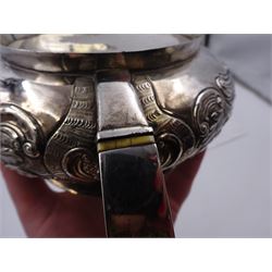 George III Irish silver teapot, of squat circular form, the body with repousse and chased floral and C scroll decoration, with capped C handle and ivory insulators, engraved to base 'Presented to Troop Sergeant Major John Percival, of the 4th Dragoon Guards by Alex D. Tait, Esq, late Captain in that corps as a mark of approbation of his steady and upright conduct when Sergeant Major of his Troop, Dublin, June 2nd 1843', hallmarked William Law, Dublin 1817, H12.5cm, This item has been registered for sale under Section 10 of the APHA Ivory Act