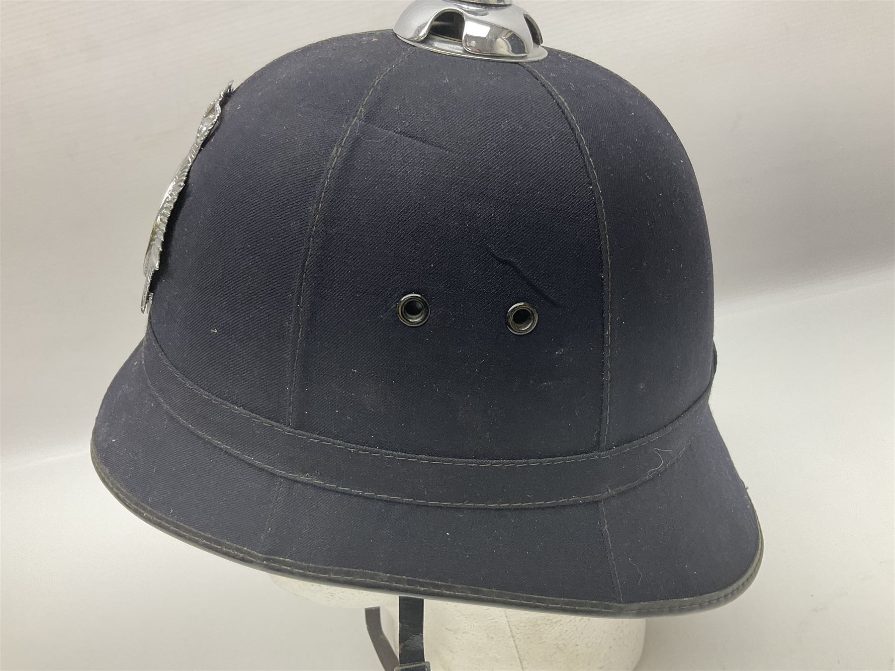 Police - Victorian turned hardwood truncheon with traces of decoration and VR cypher L42cm; Humberside Police helmet with Queens Crown helmet plate; hand lamp inscribed 'The Inspector'; and small pair of pewter figures of police officers (5)