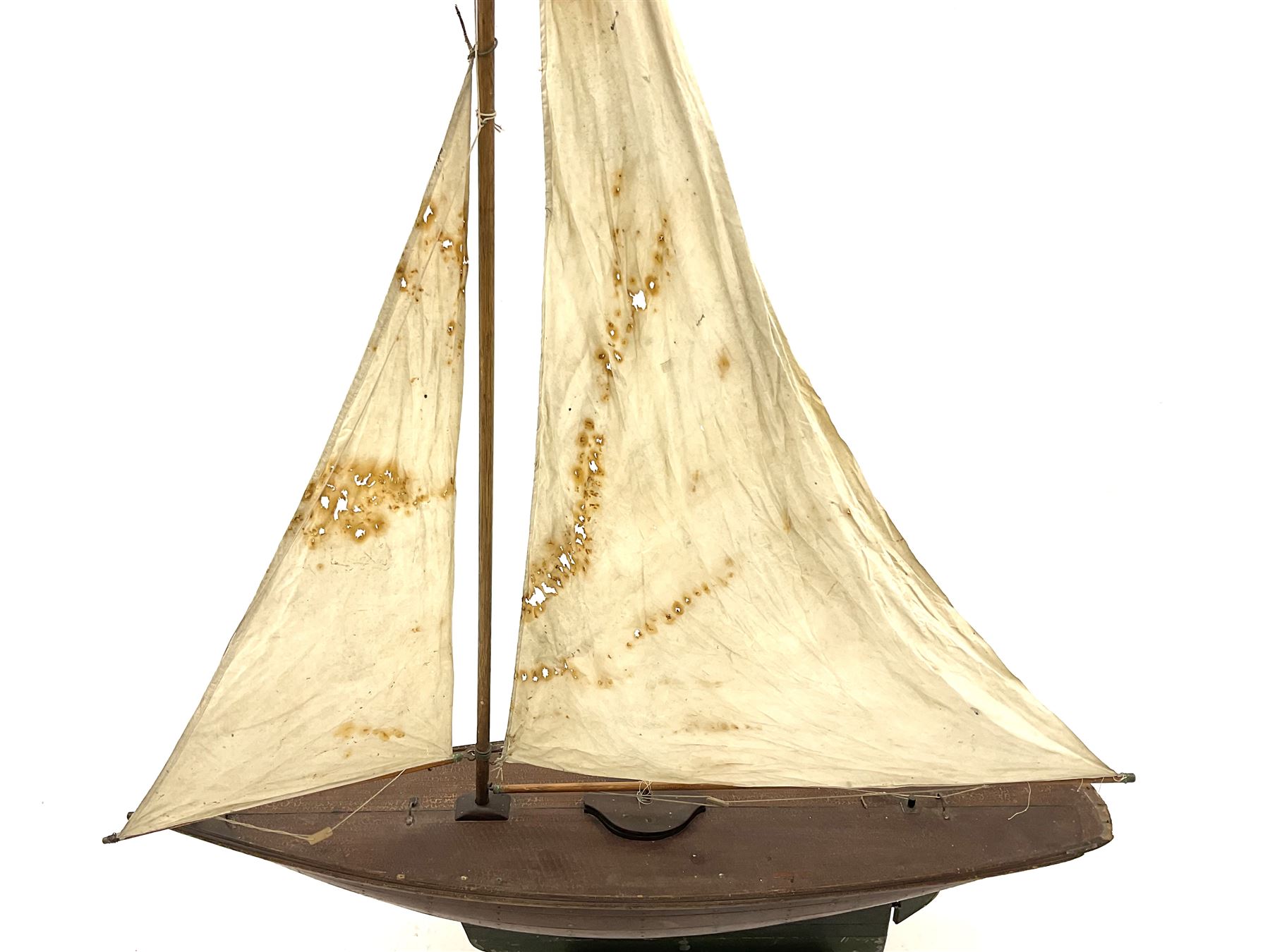 Large Victorian pond yacht, the planked hardwood hull with large lead weighted keel and working rudder, simulated planked deck and single mast with original sails; on later scratch-built wooden stand L117cm H151cm