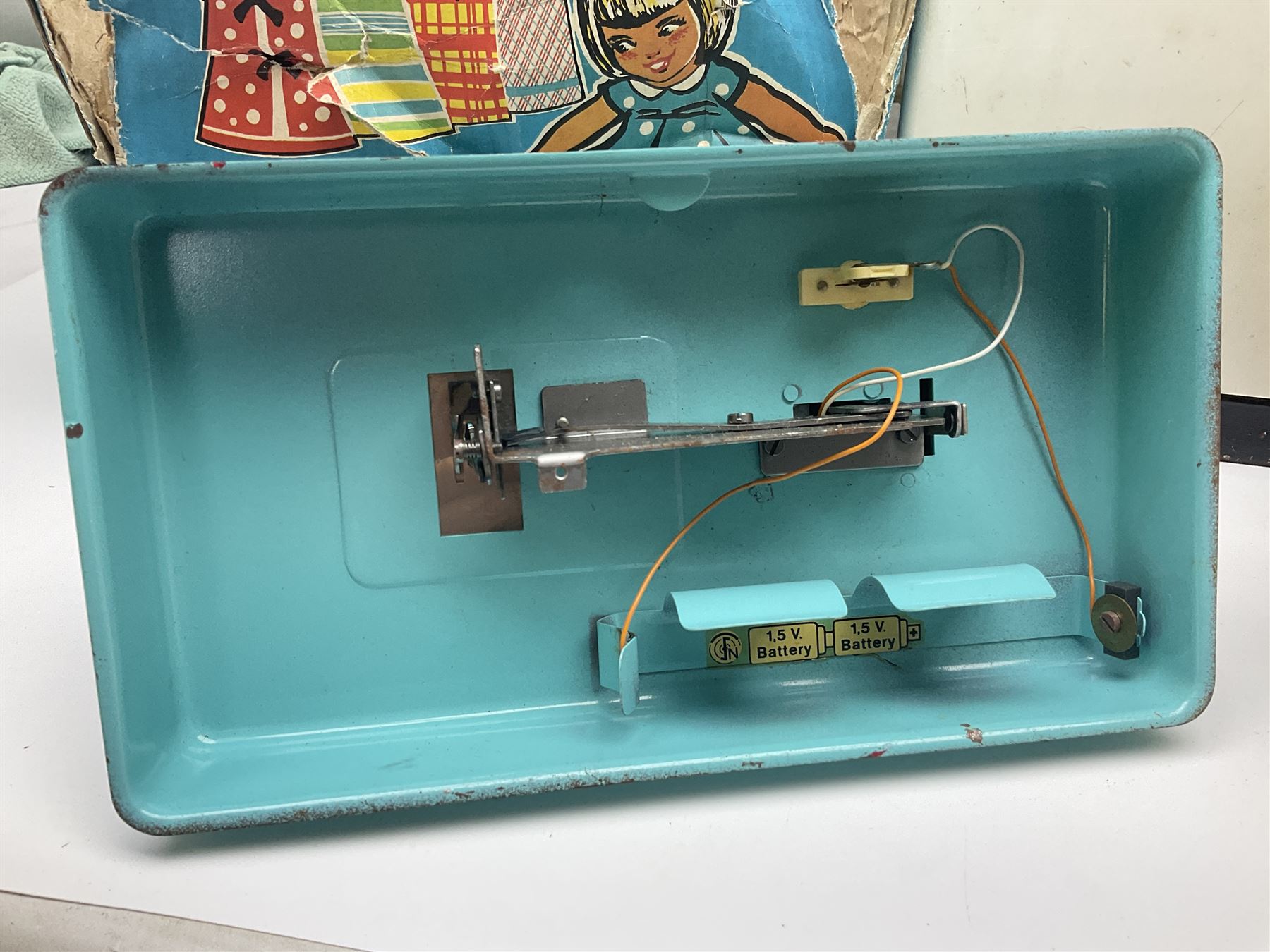 Six toy kitchen appliances - Casdon battery operated cooker; Mettoy Hoover washer; Chad Valley Hoovermatic washer; Wells Brimtoy tin-plate clockwork washer; and two Morphy Richards irons; together with a continental child's Regina sewing machine; all boxed (7)