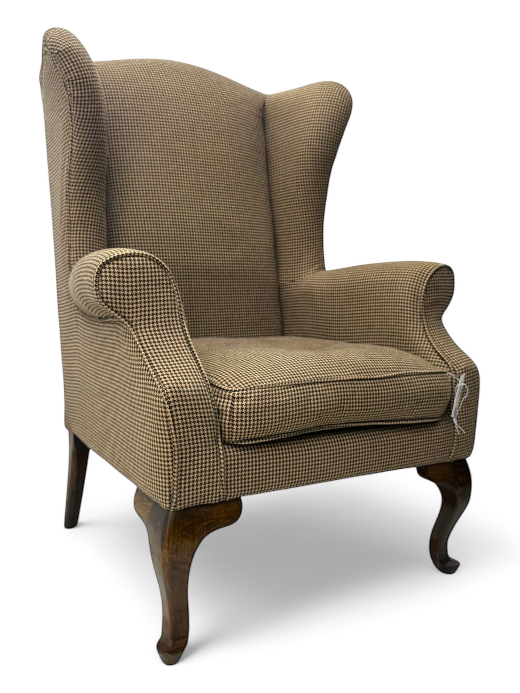 Hardwood-framed wingback armchair, upholstered in dog tooth pattern fabric, on cabriole supports 
