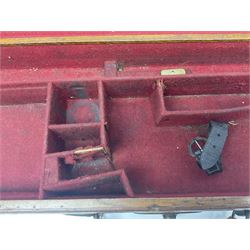 Leather shotgun case, the red baize lined interior with the trade labels of Westley Richards & Co., London, a brass plaque inscribed 'T Nevin, Mirfield, Yorkshire' to cover, with key, case to fit barrel 76cm (30 inches)  
