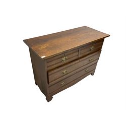 Edwardian oak straight front chest, fitted with two short and two long drawers with brass handles, raised on bracket feet