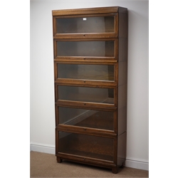  'Globe Wernicke' six tier oak library bookcase with glazed up and over doors, W85cm, H191cm, D29cm  