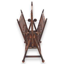 Arts and Crafts mahogany magazine stand, in the manner of Christopher Dresser, folding magazine stand, rectangular divided slatted compartments with turned spindle galleries and ball finials, the sides forming an X-frame action, raised on turned supports united by stretchers