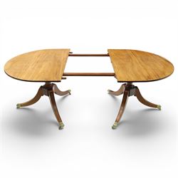 Acornman - mahogany twin pillar extending dining table, strongly grained top with inlaid edge, raised on a ring turned baluster column, above three swept supports terminating in brass paw feet above castors, two additional leaves extending the table to 242cm, with signature carved acorn, by the workshop of Alan Grainger of Brandsby