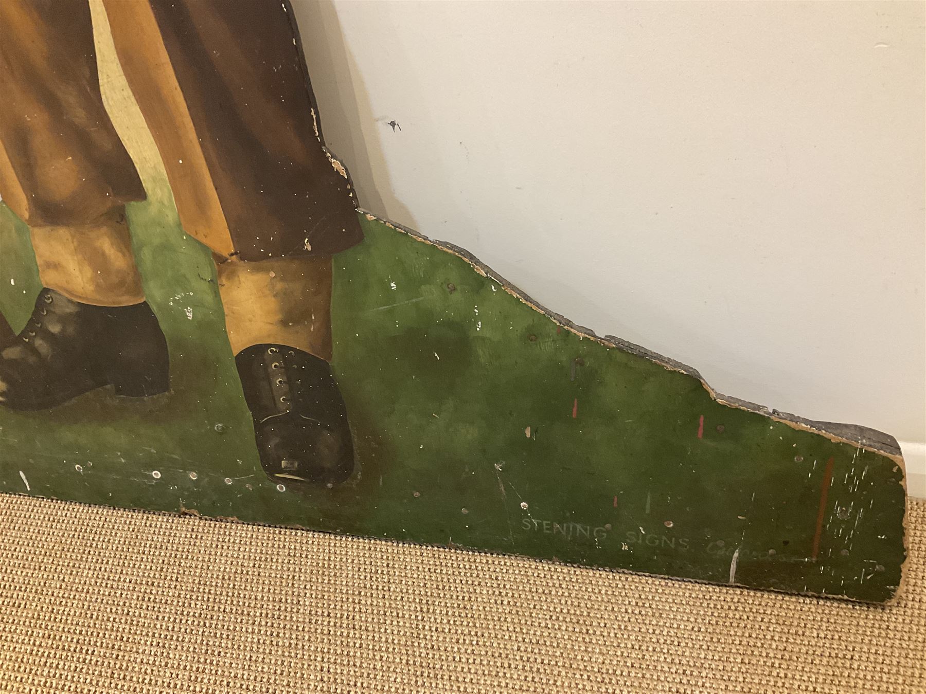 Military Outfitters hand painted life size wooden cut out figure of a WW1 soldier standing at ease holding a gun by his side, marked Stening Signs; hardboard on planked frame H199cm