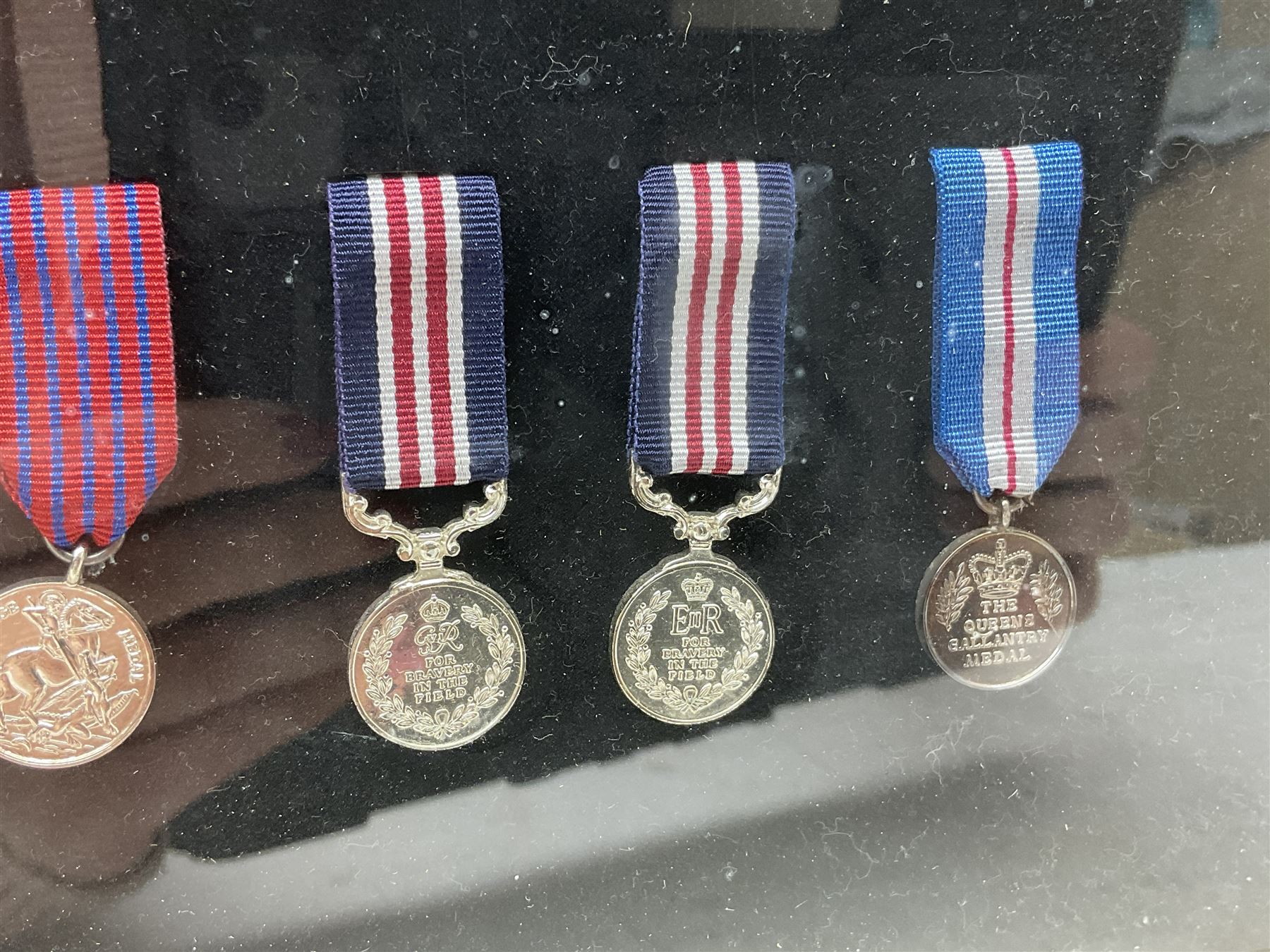 Limited edition large framed display board with sixty half-size copies of British Gallantry and Campaign Medals produced by Danbury Mint; all with ribbons and associated booklet