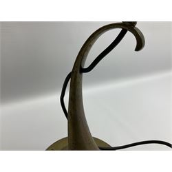 Arts & Crafts Jesson, Birkett & Co, brass table lamp or wall light, designed by Thomas Birkett, the tapering stem with adjustable ball pivot supporting a conical shade with tapering final with ball terminal, upon a circular domed base pierced for wall mounting, shade positioned upright overall H57cm

Often misattributed to Arthur Stansfield Dixon for Birmingham Guild of Handicraft, this particular lamp was designed by Thomas Birkett.
In the late 1890's Birkett worked as a metalwork at the Birmingham Guild, before later joining the Faulkner Bronze Company which went on to become Jesson, Birkett & Co in 1904. The lamp features in lighting catalogues from the firm under the model no E490.

